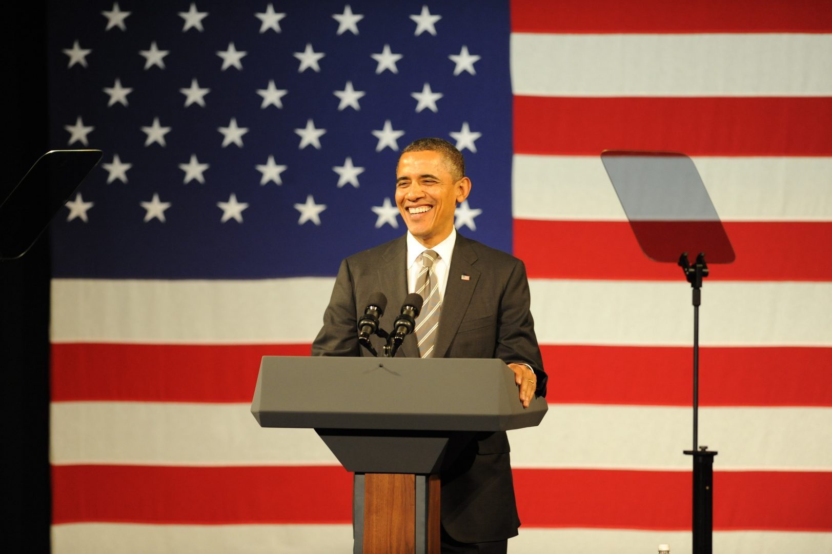 President Barack Obama standing at a podium with the American flag behind him
