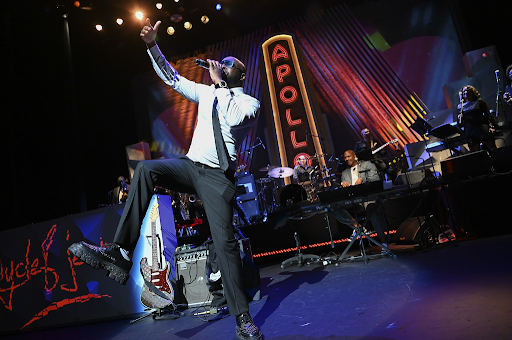 Wyclef Jean performing on the Apollo stage