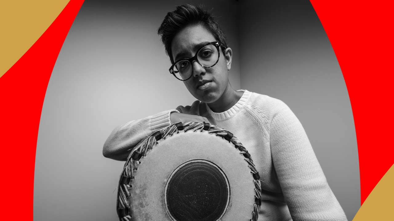 Mrudangam (South Indian percussion) artist Rajna Swaminathan featured in black and white holding a Mridangam drum.